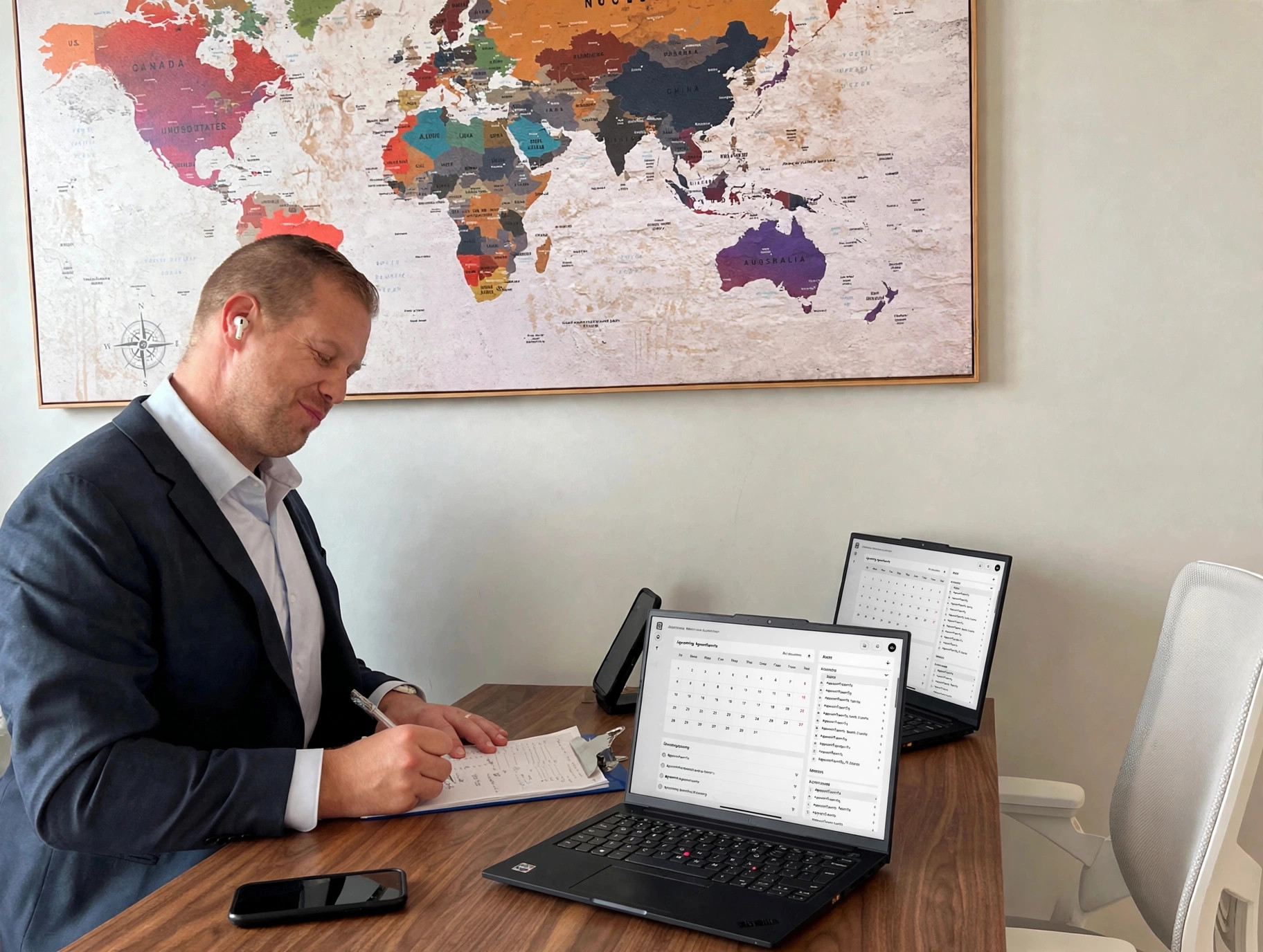 Man writing on clipboard with scheduling dashboard
